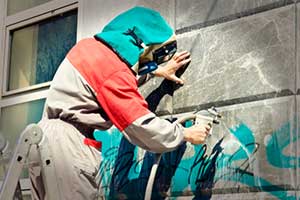professional power washer power washing graffiti off wall