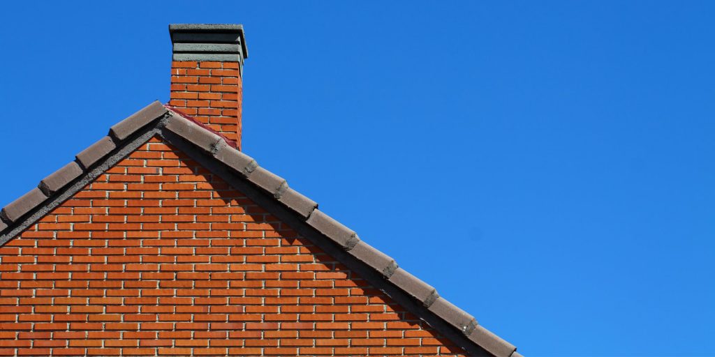 Chimney on roof in blue sky