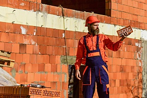 Masonry repair man holding brick