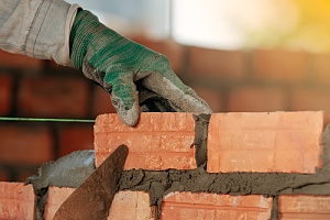 Repair man laying brick