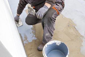 professional waterproofing concrete at a site