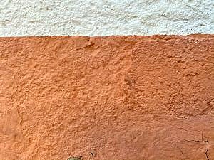 orange colored stucco wall that has been hardened