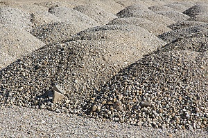 a gray substrate material in various stacks on the ground