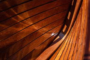 A well varnished wooden planks with black caulking