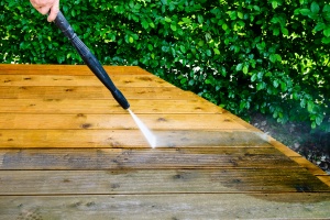 a deck showing the before and after of having powerwashing done