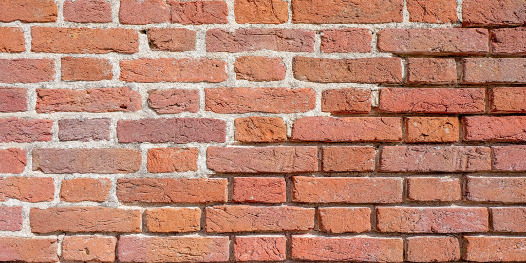 Masonry Restoration taking place on a brick wall