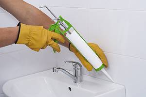 Plumber apply silicone sealant to the joint. Many people think of caulking as being limited to sealing joints