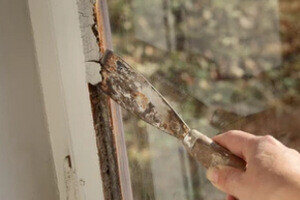 Man Taking out Window glazing with Tool