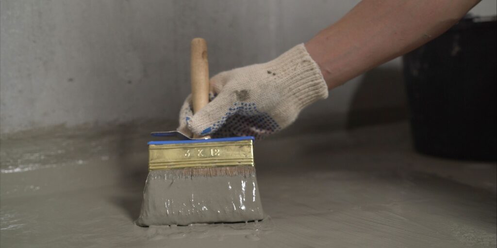 Waterproofing Concrete Floor with Mortar and Brush