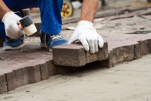 professional workers laying paving slabs for a Masonry Repair Service