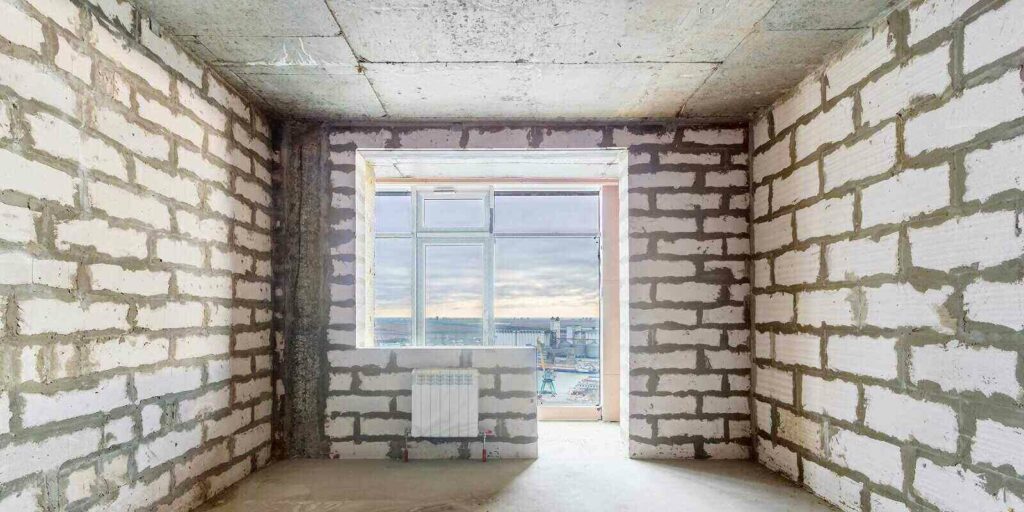 unfinished room in a residential building under construction with the window