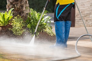 man cleaning floor for Commercial Pressure Washing