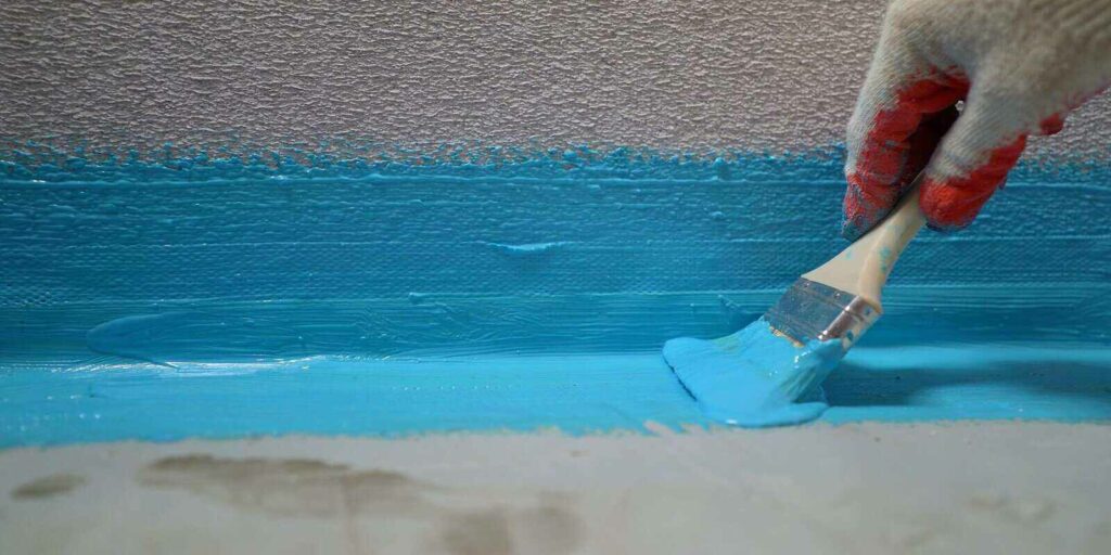 waterproofing with a blue shade brush