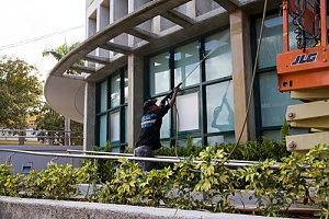a professional power washing a the lobby of a commercial building to add value a commercial building