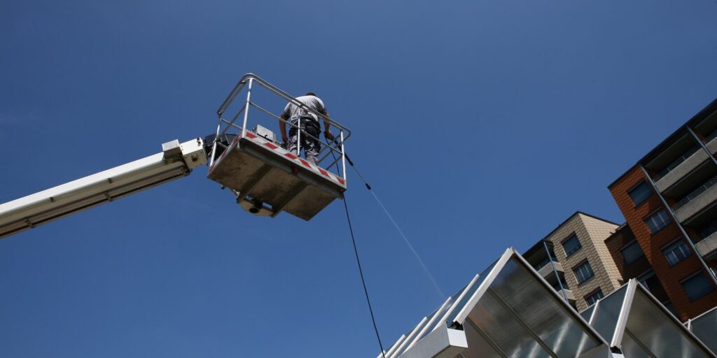 professional facade cleaning services washing a galss roof