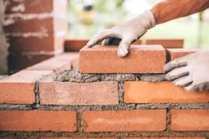 worker during brick masonry