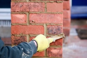 man performing brick pointing