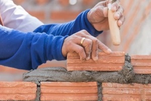 worker constructing new building walls