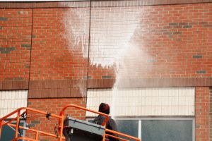 Power washing of a brick wall