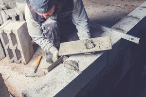 An experienced mason building a wall