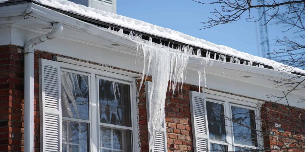 Ice damaging the roof of a house