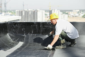 A worker doing sheet waterproofing