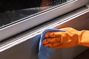 NJ worker installing water sealant on the windows